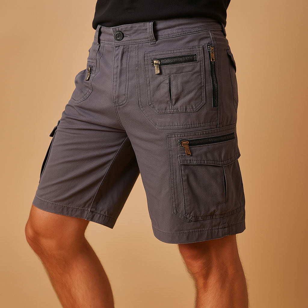 Men’s functional cargo shorts Travis with multiple zip and flap pockets, available in sand, army green, black, or dark grey. Ideal for outdoor and summer wear.