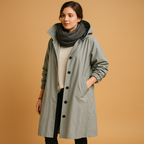 Women’s long waterproof raincoat with breathable fabric, adjustable waist, removable hood, and belt. Available in Green, Beige, and Black.
