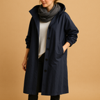 Women’s long waterproof raincoat with breathable fabric, adjustable waist, removable hood, and belt. Available in Green, Beige, and Black.